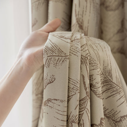 a person holding a curtain with their hand