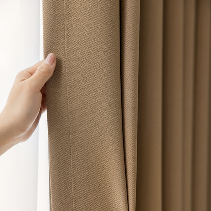 a person is holding a curtain in front of a window