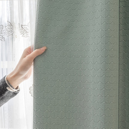 a person holding onto a curtain in front of a window