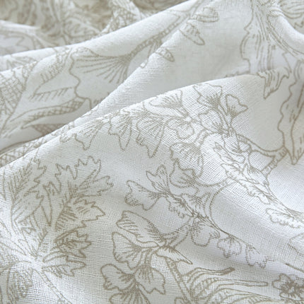 a close up of a white fabric with a flower pattern
