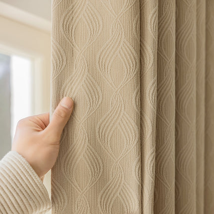 a person holding a curtain with their hand