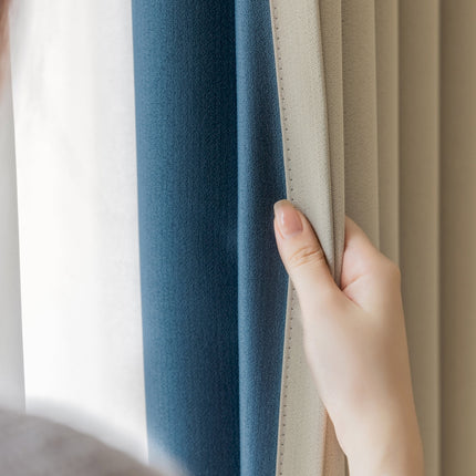a person holding a curtain with their hand