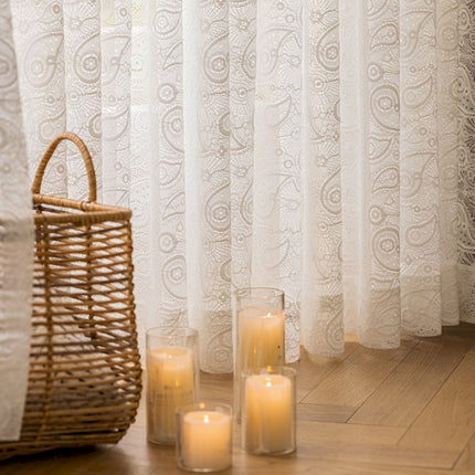 a group of candles sitting on a wooden floor next to a window