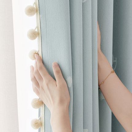 a woman's hand on the curtain of a window
