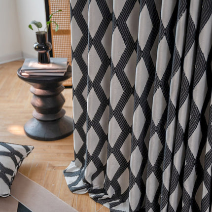 a living room with a black and white patterned curtain
