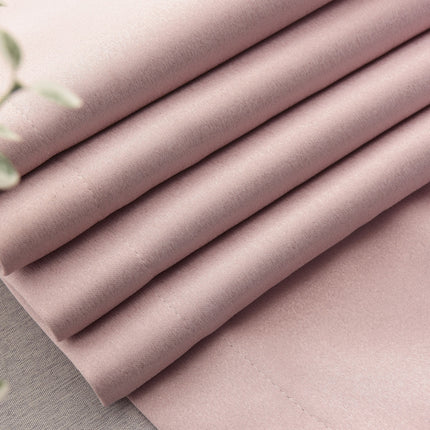 a close up of a pink sheet on a table