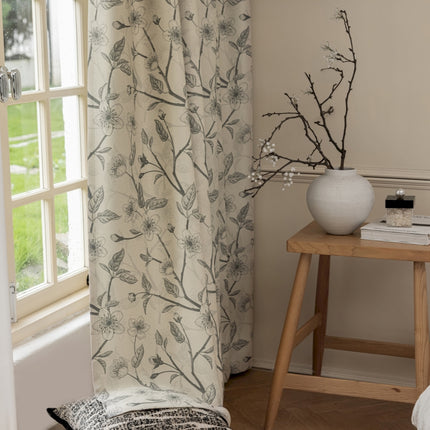 a white vase sitting on top of a table next to a window