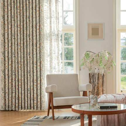 a living room filled with furniture and a window covered in curtains