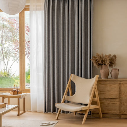 a living room with a chair and a window