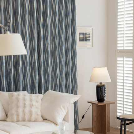a living room with a white couch and a lamp