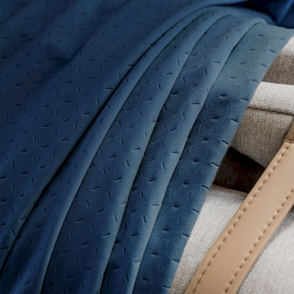 a close up of a bed with a blue blanket