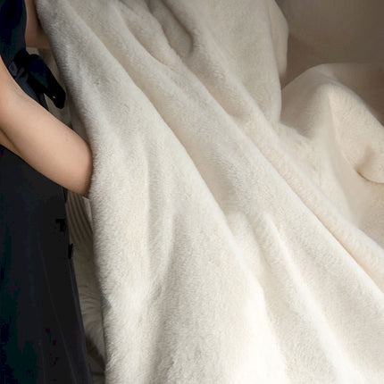 a person wrapped in a blanket on a bed