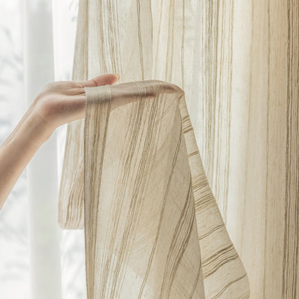 a person's hand is holding a curtain in front of a window