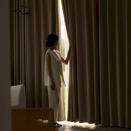 a woman standing in front of a window