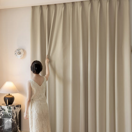 a woman in a wedding dress looking out a window