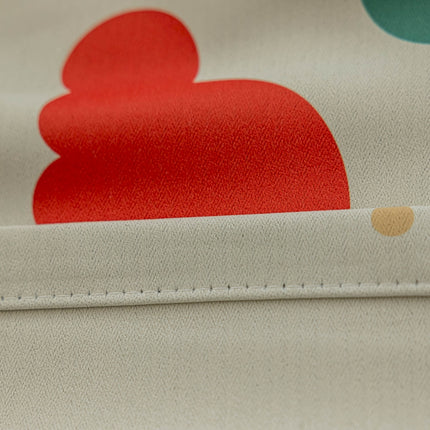a close up of a fabric with a red heart on it