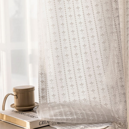 a coffee cup sitting on top of a book next to a window