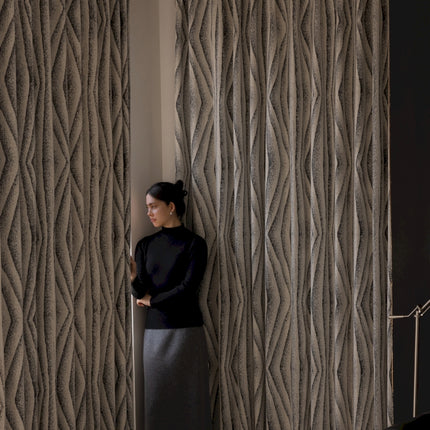 a woman leaning against a wall with her hands on her hips