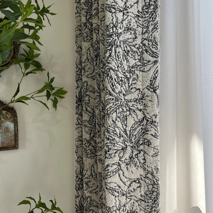 a plant is hanging on a wall next to a curtain