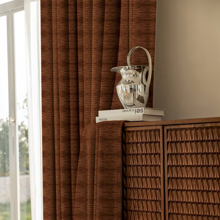 a vase sitting on top of a shelf next to a window
