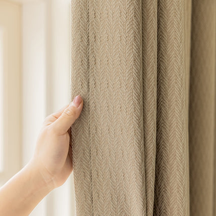 a hand is holding a curtain in front of a window
