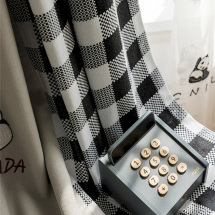 a black and white checkered curtain with buttons on it