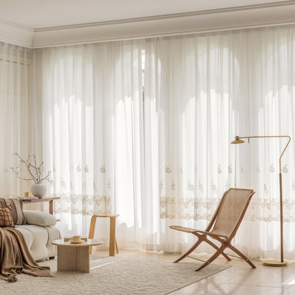 a living room with a white couch and a chair