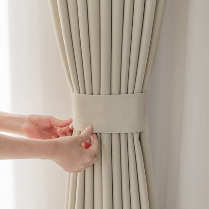 a woman's hand pulling a curtain off of the side of a window