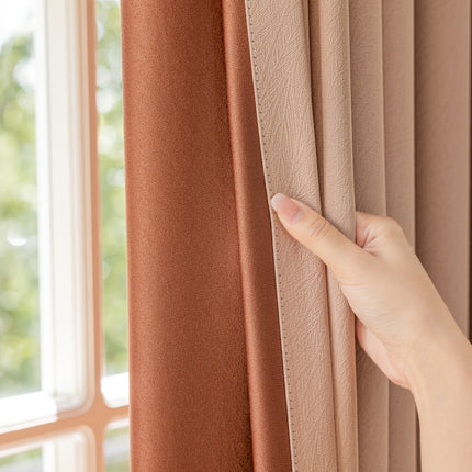 a person's hand on a curtain with a window in the background