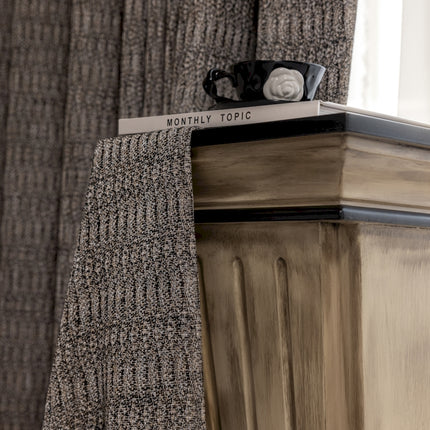 a close up of a tie on top of a dresser