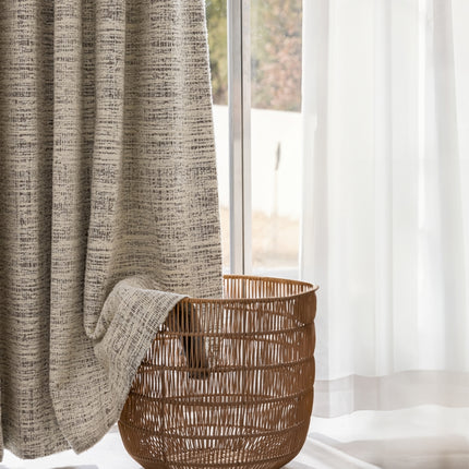 a wicker basket sitting in front of a window