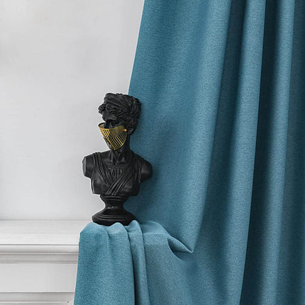 a statue of a man is on a curtain rod