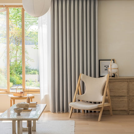 a living room filled with furniture and a large window
