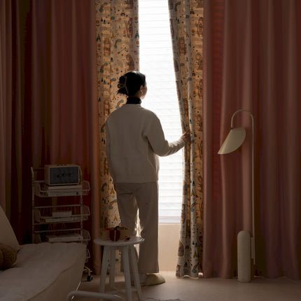 a woman standing in front of a window