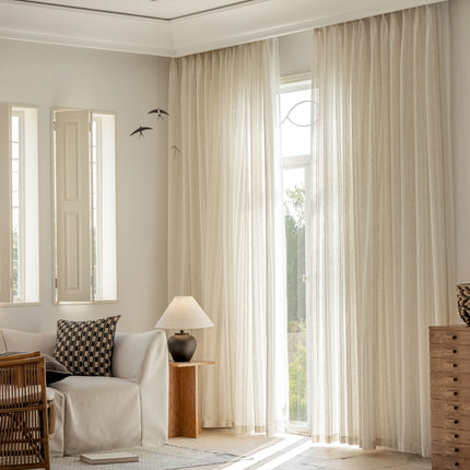 a living room filled with furniture and a large window