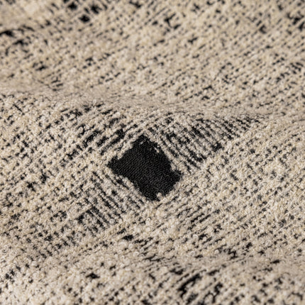 a close up of a sweater with a black hole in the middle