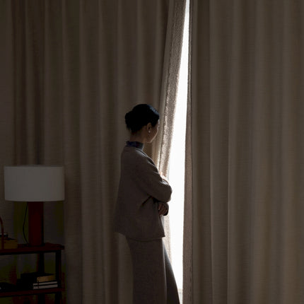 a woman standing in front of a window