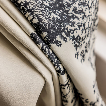 a close up of a black and white pillow on a chair