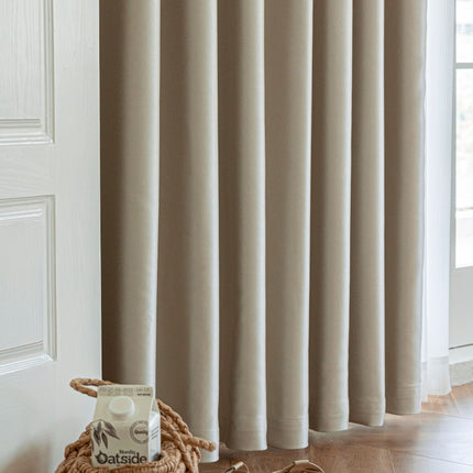 a bag of oats sitting on the floor next to a curtain