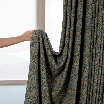 a person is opening a curtain with their hand