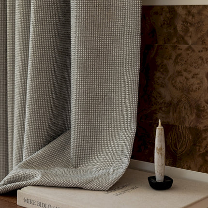 a white candle sitting on top of a book
