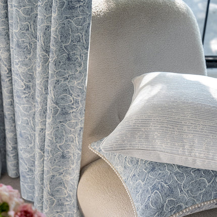 a close up of a chair with a pillow on it