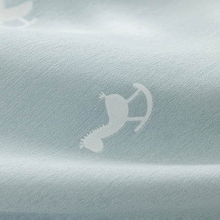 a close up of a shirt with a bird on it