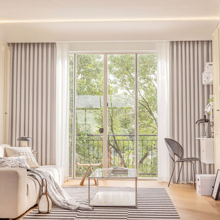 a living room filled with furniture and a sliding glass door