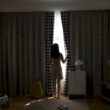 a woman standing in front of a window