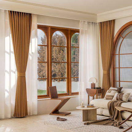 a living room filled with furniture and large windows