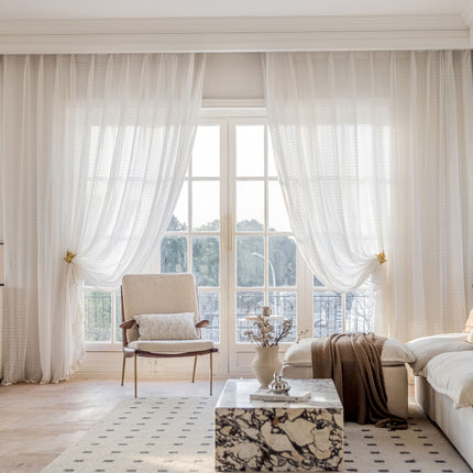 a living room filled with furniture and a large window
