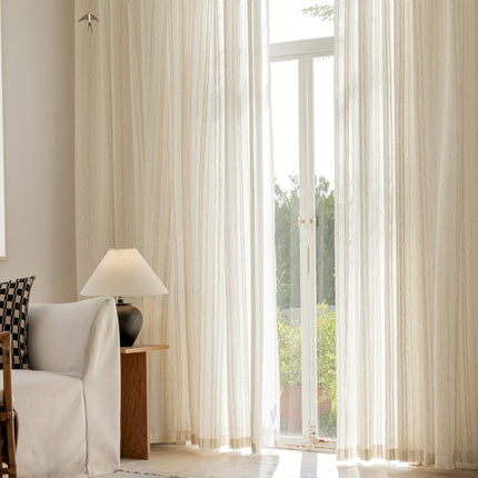 a living room with a white couch and a large window
