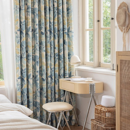 a bedroom with a bed, desk and window