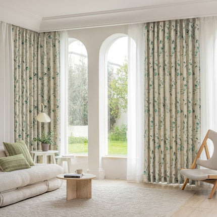 a living room filled with furniture and large windows